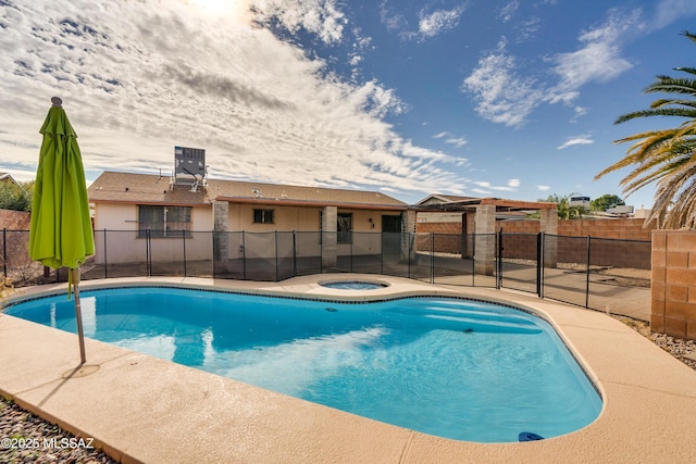 view of swimming pool featuring an in ground hot tub