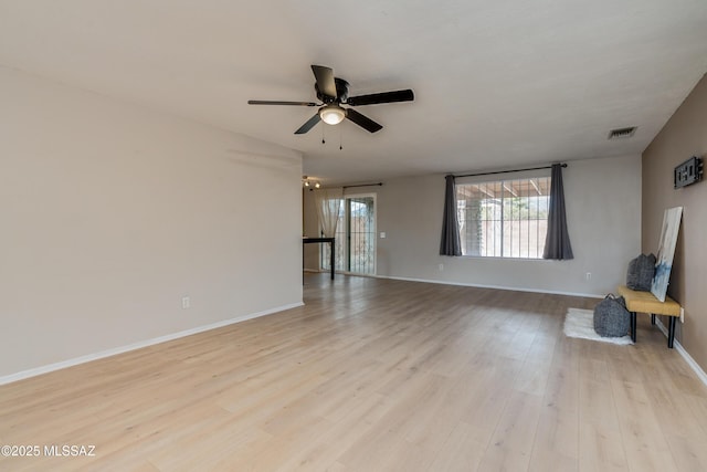 unfurnished living room featuring ceiling fan and light wood-type flooring