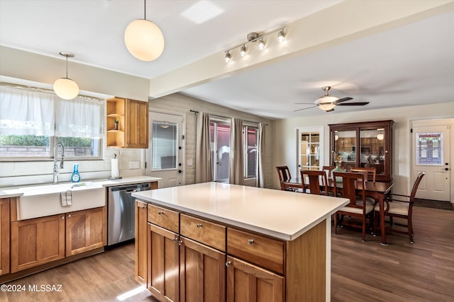 kitchen featuring tasteful backsplash, a sink, dark wood finished floors, brown cabinets, and stainless steel dishwasher