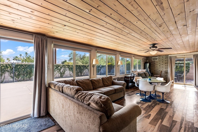 sunroom featuring ceiling fan and wooden ceiling