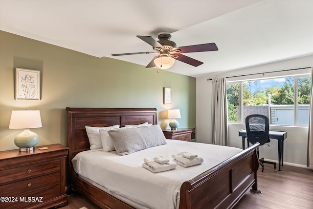 bedroom with ceiling fan and dark hardwood / wood-style flooring