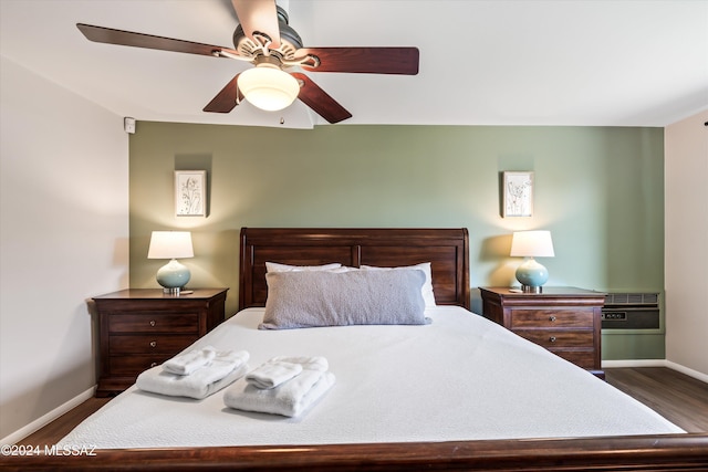 bedroom with ceiling fan and dark wood-type flooring