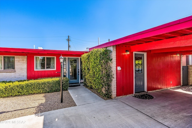 property entrance with a carport