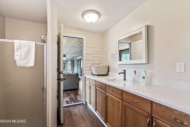 bathroom with curtained shower, vanity, a healthy amount of sunlight, and hardwood / wood-style flooring