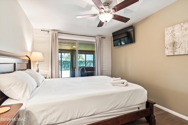 bedroom featuring access to exterior, dark hardwood / wood-style flooring, and ceiling fan