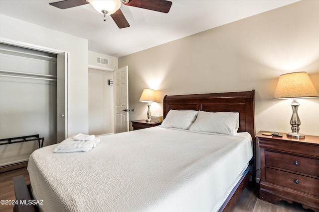 bedroom featuring ceiling fan, dark wood-type flooring, and a closet