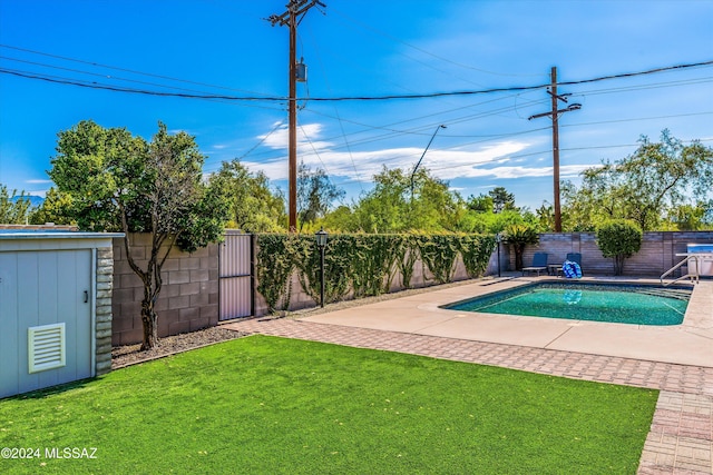 view of pool featuring a lawn and a patio area