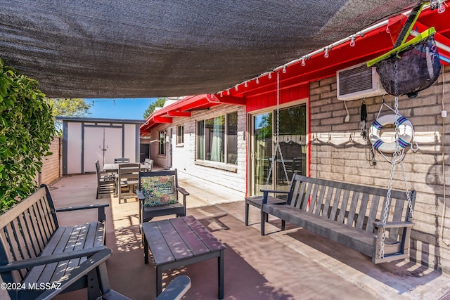 view of patio / terrace featuring an outdoor living space and a shed