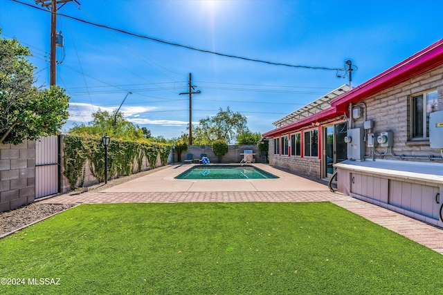 view of swimming pool featuring a patio, a yard, a fenced backyard, and a fenced in pool