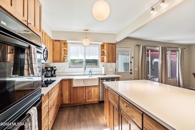 kitchen featuring dark wood finished floors, tasteful backsplash, open shelves, appliances with stainless steel finishes, and a sink
