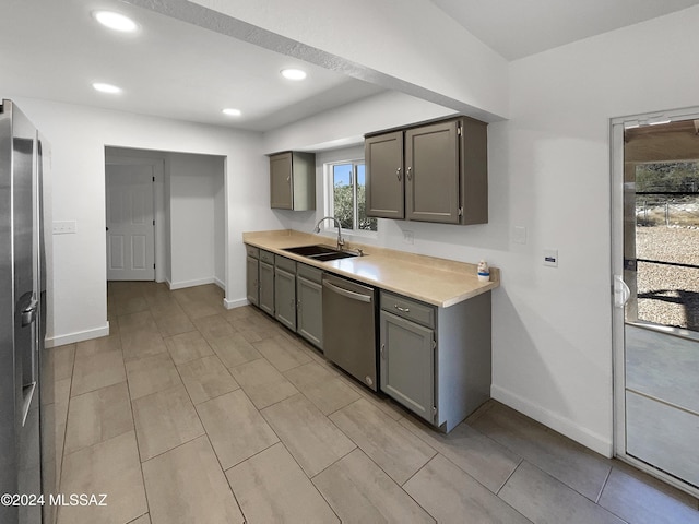 kitchen featuring appliances with stainless steel finishes, gray cabinetry, and sink