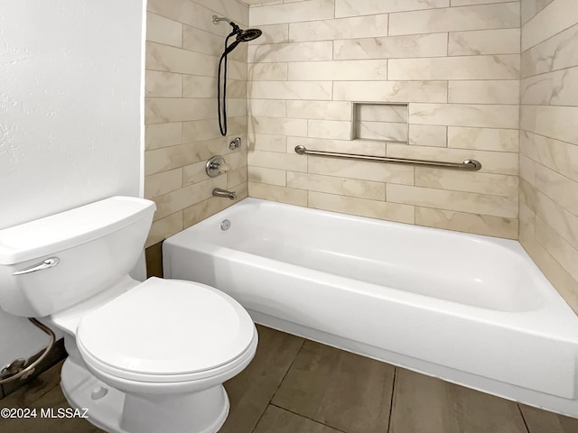 bathroom featuring tile patterned floors, toilet, and tiled shower / bath