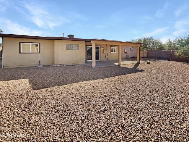 rear view of house featuring a patio area and central AC