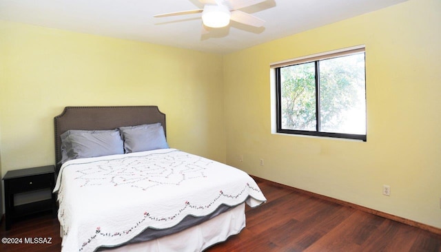 bedroom with dark hardwood / wood-style floors and ceiling fan