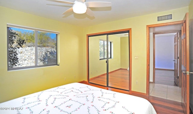 bedroom featuring ceiling fan, hardwood / wood-style floors, and a closet