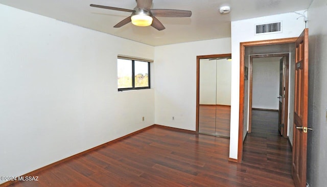 unfurnished bedroom with ceiling fan and dark hardwood / wood-style flooring