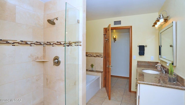 bathroom with independent shower and bath, vanity, and tile patterned floors