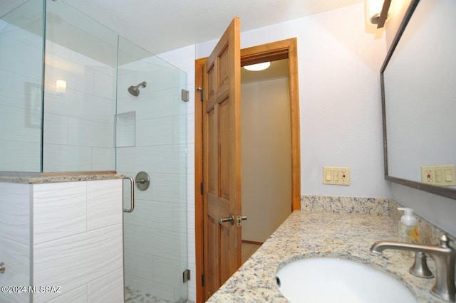 bathroom with vanity and an enclosed shower