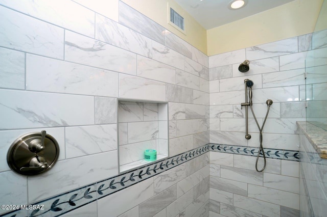 bathroom with tiled shower