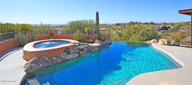 view of pool with an in ground hot tub