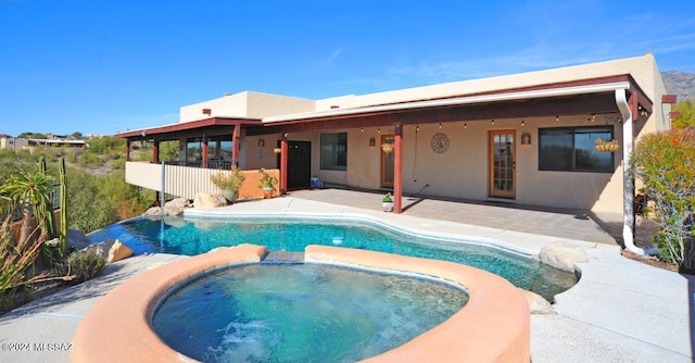 view of pool featuring an in ground hot tub and a patio