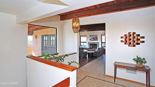 hall with beamed ceiling, wood ceiling, and tile patterned flooring