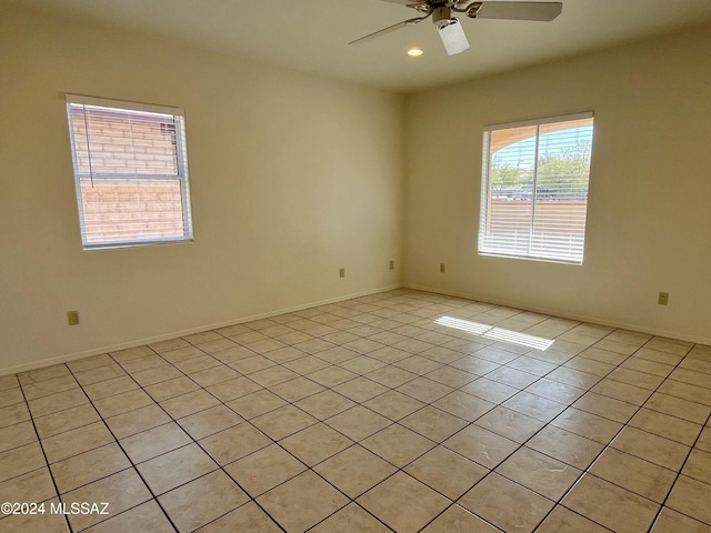 tiled spare room featuring ceiling fan