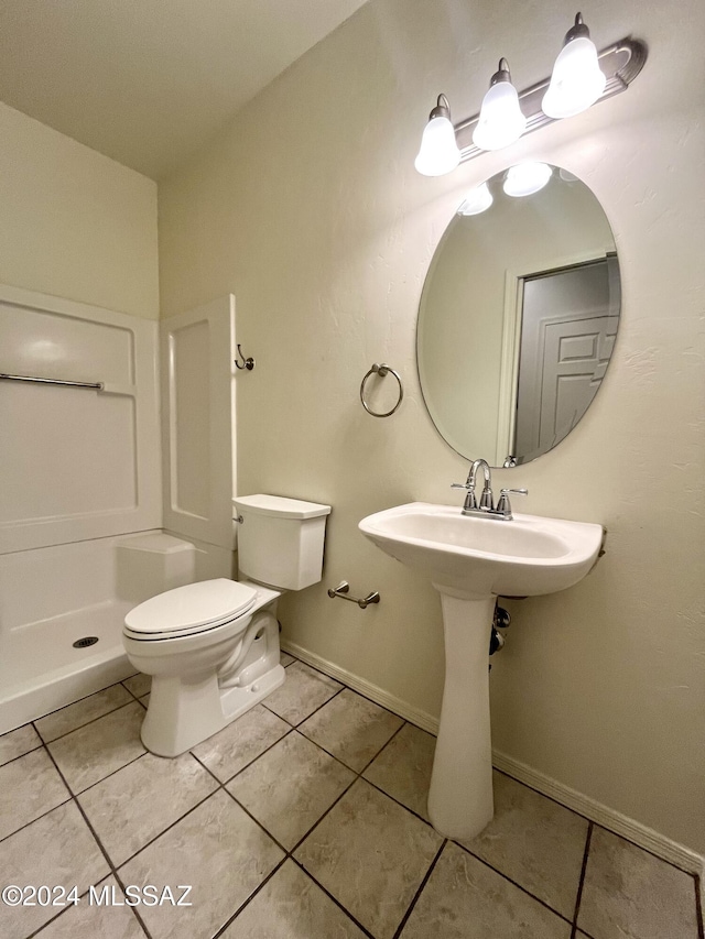 bathroom featuring tile patterned flooring and toilet