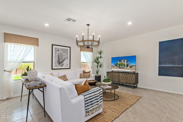 tiled living room with a notable chandelier