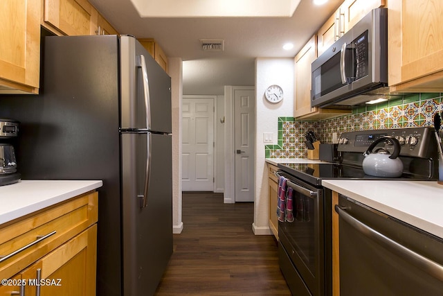 kitchen featuring backsplash, light brown cabinets, stainless steel appliances, and dark wood-type flooring