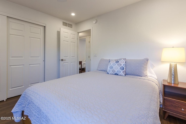 bedroom featuring a closet and dark wood-type flooring