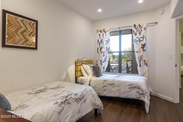 bedroom with dark hardwood / wood-style flooring