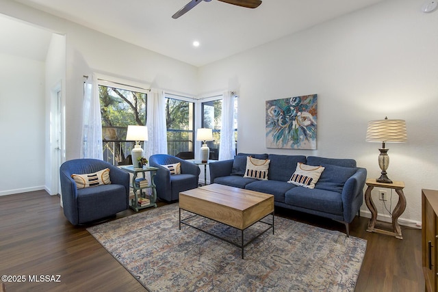 living room with ceiling fan and dark wood-type flooring