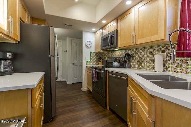 kitchen featuring sink, light brown cabinets, stainless steel appliances, dark hardwood / wood-style flooring, and backsplash