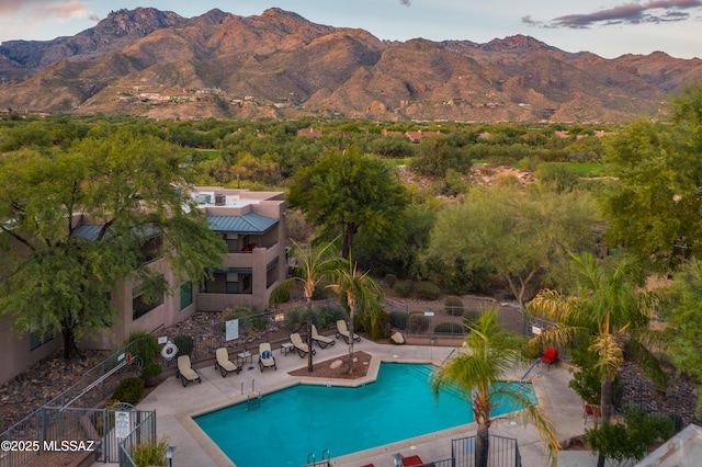 view of pool featuring a mountain view and a patio