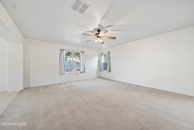 carpeted empty room with ceiling fan