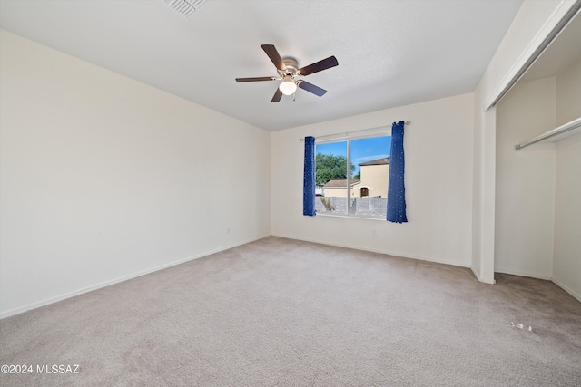 unfurnished bedroom featuring carpet flooring, ceiling fan, and a closet