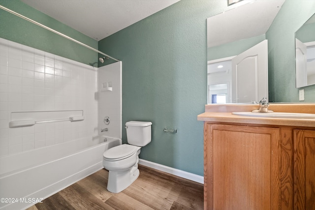 full bathroom featuring toilet, hardwood / wood-style floors, vanity, and washtub / shower combination