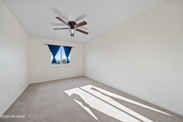 empty room with ceiling fan and light colored carpet