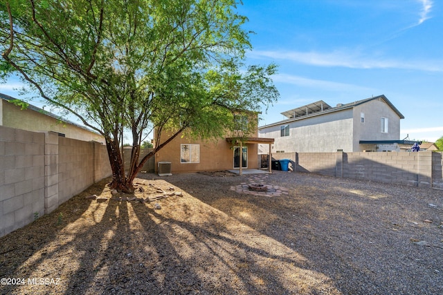 rear view of property with central AC