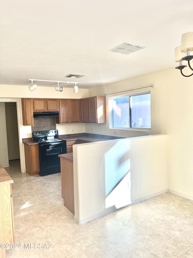 kitchen featuring light tile patterned floors, rail lighting, and black electric range oven