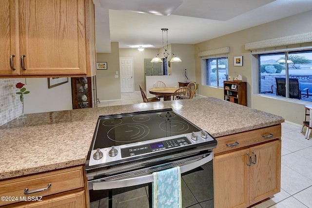 kitchen featuring stainless steel range with electric stovetop and light tile patterned floors