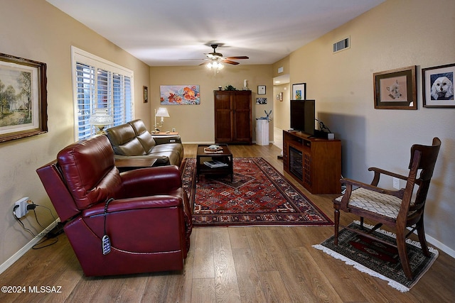 living room with ceiling fan and hardwood / wood-style flooring