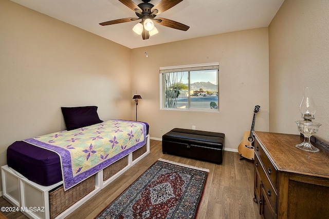 bedroom with ceiling fan and hardwood / wood-style flooring