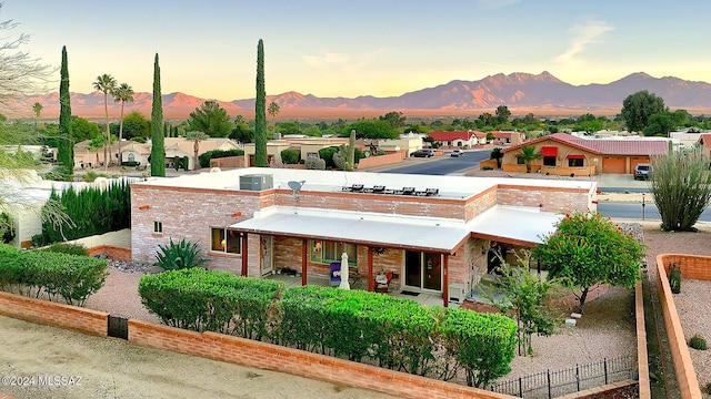 view of front of property featuring central AC and a mountain view