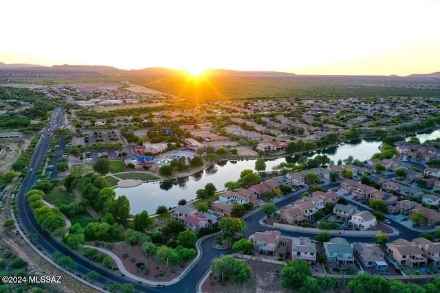 aerial view at dusk with a water view