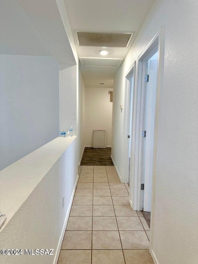 hall featuring light tile patterned floors