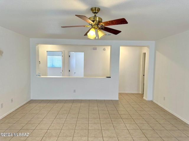 unfurnished room featuring ceiling fan and light tile patterned flooring