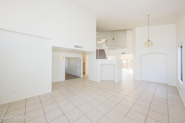 tiled empty room with a towering ceiling