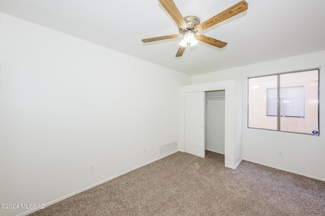 unfurnished bedroom featuring ceiling fan, a closet, and carpet floors